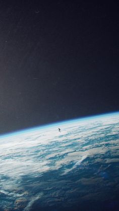 an airplane flying over the earth at night