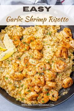 garlic shrimp risotto in a skillet with lemon wedges and parsley