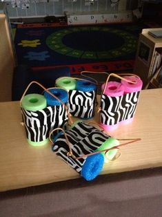 several zebra - print bags are sitting on a table in front of a bookcase