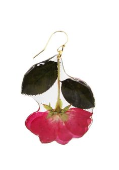 a pair of black and pink flowers hanging from gold - toned earwires