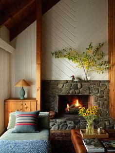 a living room filled with furniture and a fire place next to a wall mounted fireplace