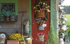 the front porch is filled with potted plants and other things to decorate on it