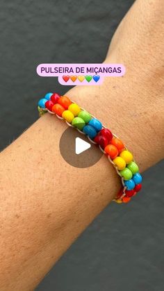 a person wearing a colorful bracelet on their arm with the words pulseria de micagas