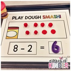 a printable play dough smash game with numbers and candy on the table next to it