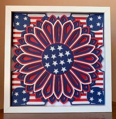 an american flag paper cutout in a white frame