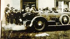 an old black and white photo of people in a car