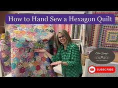 a woman standing in front of a quilt with the words how to hand sew a hexagon quilt