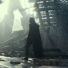 a man standing in front of a pile of rubble