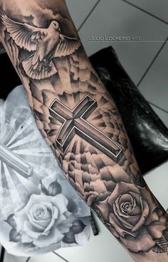 a person with a cross and roses tattoo on their arm