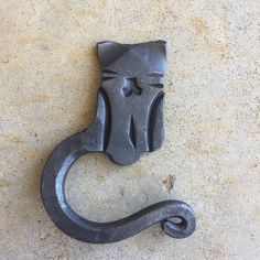 a metal hook with a cat's face on it