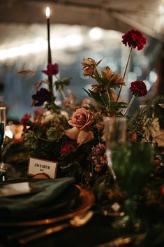 the table is set with flowers and candles