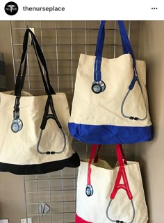 three purses hanging up on a wall in front of a metal rack with hooks