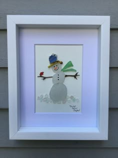 a white frame with a snowman on it