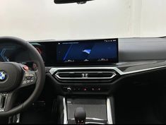 the interior of a bmw vehicle with an entertainment system and steering wheel controls, including gps