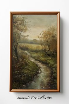 a painting hanging on the wall next to a wooden framed art piece with a river running through it