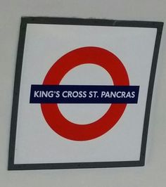 a red and white sign that says king's cross st pancras on it