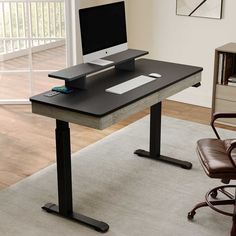 a computer desk with a monitor and keyboard on it