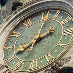 a large clock on the side of a building with roman numerals and stars