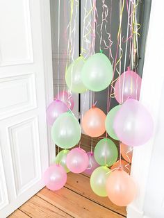 balloons are hanging from the ceiling in front of a door