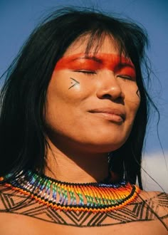 a native american woman with her eyes closed