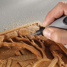 a person using a computer mouse to cut wood