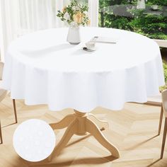 a white table and chairs in front of a window with flowers on the table top