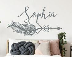 a bedroom with a large bed and wall decal that says, sophiia