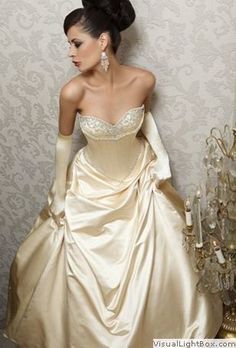 a woman in a wedding dress leaning against a wall