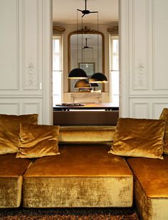 a living room filled with lots of brown furniture