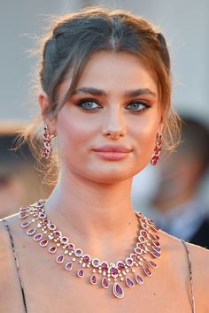 the actress wearing an elaborate necklace and earrings is seen on the red carpet at the venice film