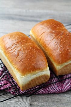 two loaves of honey white bread on a cooling rack with the title above it