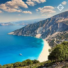 an aerial view of the beach and mountains