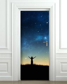 an open door with the silhouette of a person standing in front of a night sky