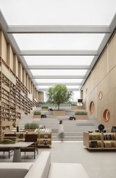 the interior of a library with lots of bookshelves and couches in it