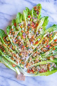 lettuce with chickpeas and garbanzo dressing on a marble surface