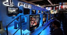 people are playing video games at the playstation booth