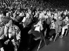 an old black and white photo of people sitting in the stands at a sporting event