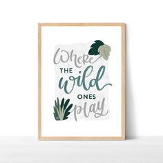 a framed poster with the words where the wild ones play in green and grey on it