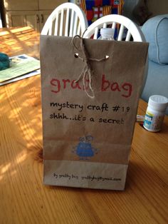 a brown paper bag sitting on top of a wooden table