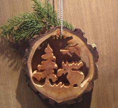 a wooden ornament hanging from a tree