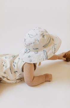 Keep your little sailor shaded with this adorable bucket hat featuring a broad brim, an adjustable strap and a fun print packed with friendly sea creatures. 100% organic cotton Machine wash, tumble dry Imported Baby Logo Branding, Cute Overalls, Backyard Picnic, Toddler Pajamas, Life Aquatic, Baby Sleepers, Knitted Booties, Sustainable Manufacturing, Cotton Romper