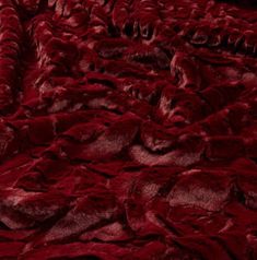 a close up view of the texture of a red furnishing material that is soft and fluffy