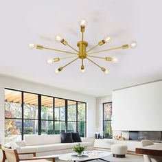 a living room filled with furniture and lots of windows