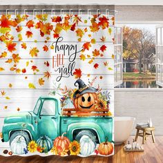 a shower curtain with an image of a truck and pumpkins on the bed in front of it