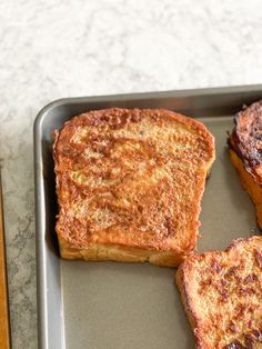 three pieces of toast sitting on top of a pan