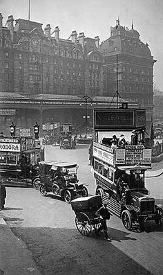 an old black and white photo of people on the street