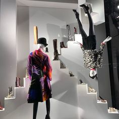 two mannequins dressed in colorful clothing and hats