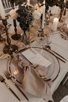 the table is set with silverware and place settings for an elegant dinner or reception