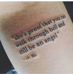 a person with a tattoo saying she's proof that you can walk through hell and still be an angel