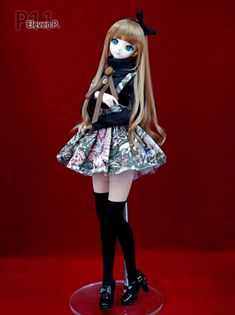 a doll with long blonde hair and blue eyes wearing a dress, black tights and boots